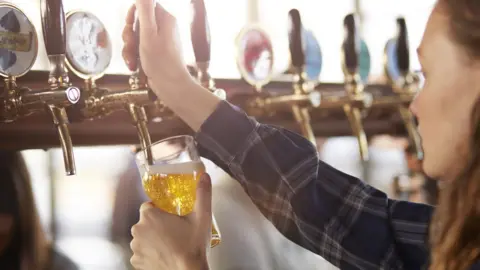 Getty Images woman pouring a pint