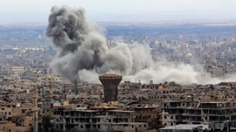 AFP Smoke rises from the besieged rebel-held Eastern Ghouta, Syria, on 27 February 2018