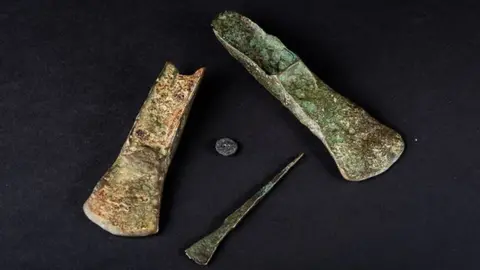 Norfolk Museums Service The Holme Bronze Age beach finds, two palstaves (axes), a chisel and a button