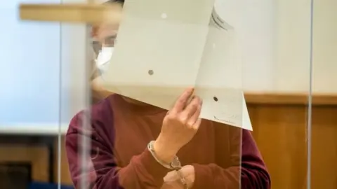 Reuters Syrian defendant Eyad A. arrives to hear his verdict in the courtroom in Koblenz, Germany February 24, 2021.