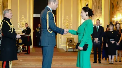 Aaron Chown Ayette Bounouri receiving her Queen's Gallantry medal from the Prince of Wales