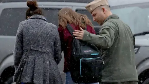 Getty Images Student and her guardians