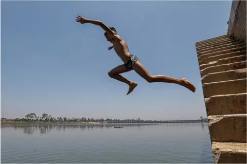 Khaled Desouki/AFP A boy diving into the River Nile