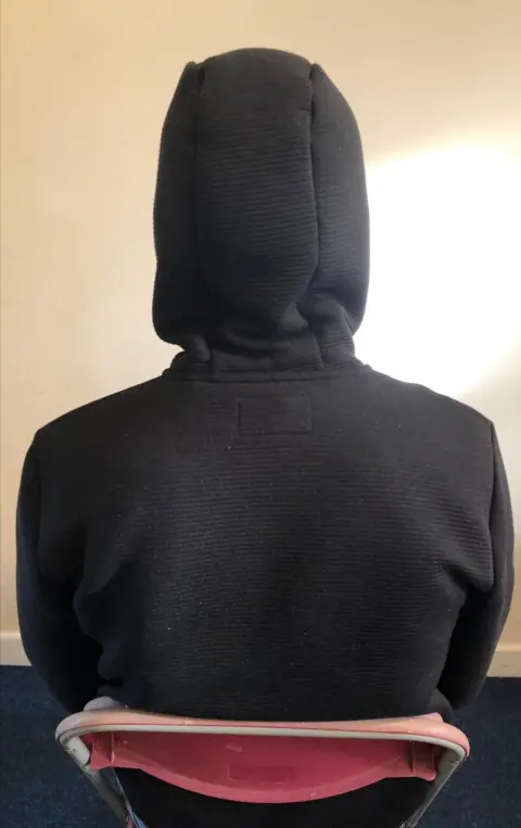 Taken by family Man in hoody, back to camera