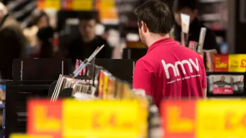 Getty Images Staff member in a HMV shop