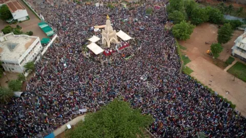 Getty Images This aerial view shows Malians gathering at the Independence square in Bamako on June 5, 2020.