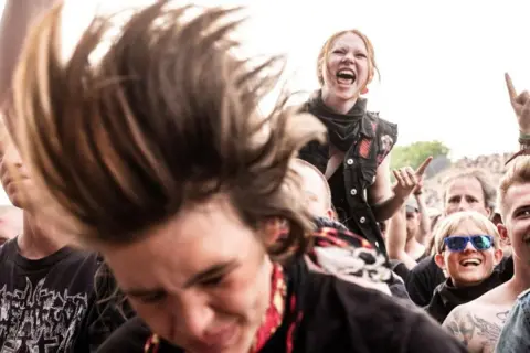 Helle Arensbak / Scanpix via Reuters The audience reacts as Halestorm performs at Copenhell