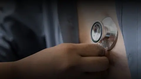 UEA A stethoscope being held against a chest