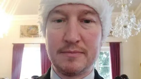 A recent image of Shaun Slator wearing a Christmas hat