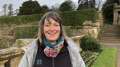 A woman in a formal garden