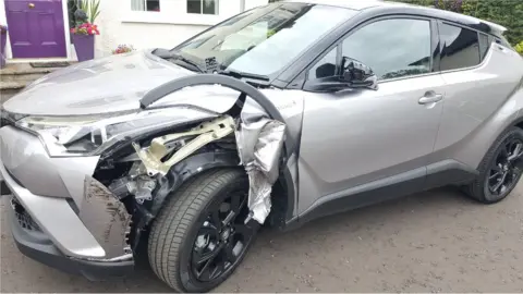 The damaged car that was being used by two American golf fans
