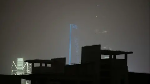 Getty Images Outline of Shanghai World Financial Centre and Jin Mao Tower in Pudong district during a sandstorm.