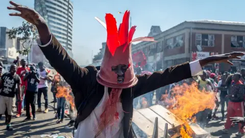 EPA A man gestures during a protest against polling results in Harare, Zimbabwe, 1 August 2018