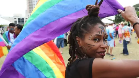 Sean Drakes via Getty Supporters of LGBT rights and equality conclude three weeks of solidarity-building events with a festive parade during the first annual Pride Arts Festival on July 28 in Port of Spain, Trinidad.