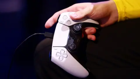 Getty Images Man holding PS5 controller