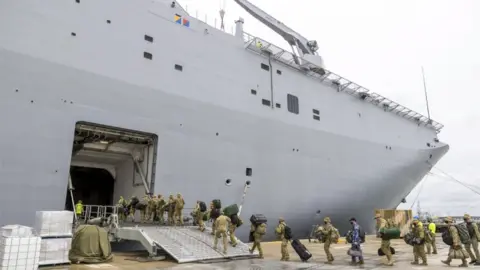 EPA Australian Defence Force (ADF) personnel embarking onto HMAS Adelaide at the Port of Brisbane, Queensland, Australia, 20 January 2022 (issued 21 January 2022), before departure on Operation Tonga Assist 202 following the eruption of Tonga"s Hunga Tonga- Hunga Ha"apai underwater volcano on 15 January.