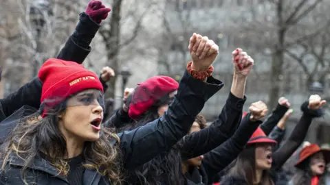 Getty Images Women protest against rape as they sing a song in front of the court while Harvey Weinstein attends a pretrial session on January 10, 2020 in New York City