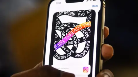 IDREES MOHAMMED/EPA-EFE/REX/Shutterstock Threads logo on a phone