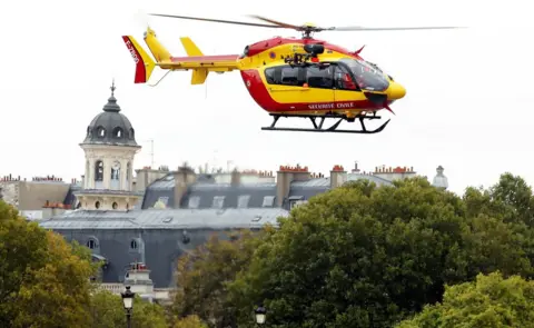 Reuters A rescue helicopter is seen after an attack on the police headquarters in Paris.