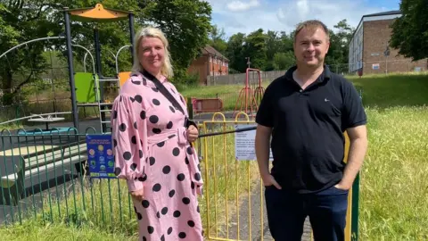 Two residents, a man and woman, stood outside their local park