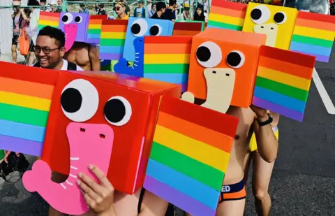 AFP Participants wear stylised rainbow elephant masks as they take part in the annual Pride parade in Taipei