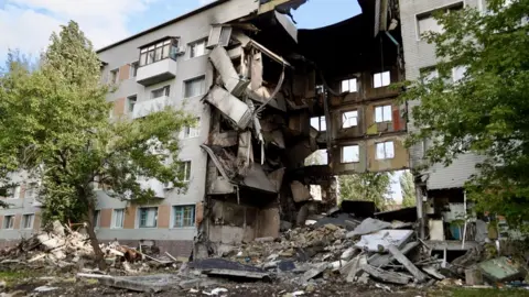 BBC An apartment block damaged by shelling in Bakhmut