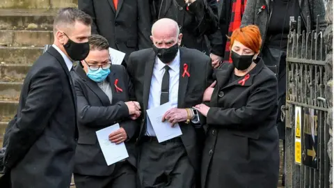 PA David Lewis being supported by family