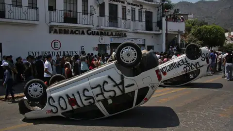 EPA Overturned cars during a protest in Mexico