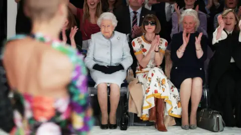 Getty Images The late queen at London Fashion Week in 2018