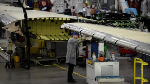 Reuters A worker at Bombardier's Belfast plant