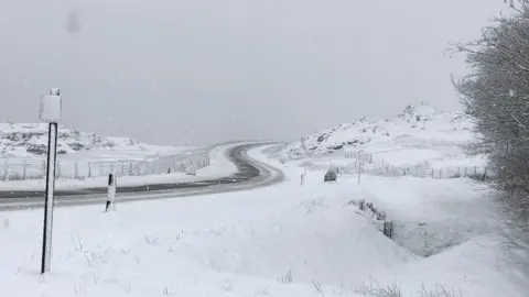 Snow traps cars and closes schools in north Wales