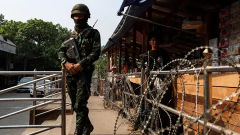 Getty Images A Thai military personnel stands guard near the Thai-Myanmar border in Mae Sot, Thailand on April 11, 2024. Myanmar ethnic rebels and civilian militia took over from the military forces the town of Myawaddy, a crucial trade hub near the Thai border.