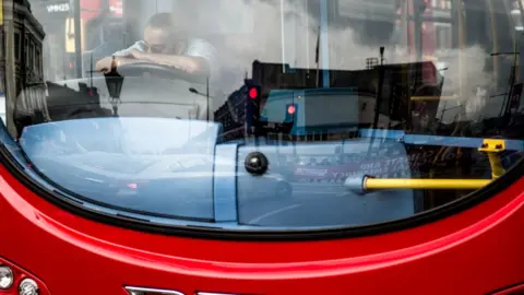 Getty Images Bus driver looks frustrated