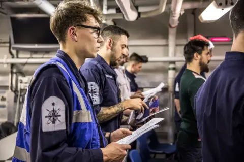 PA Handout photo issued by the Ministry of Defence of crew onboard Royal Navy frigate HMS St Albans escorting a Russian warship through the North Sea and areas of UK interest, 25 December