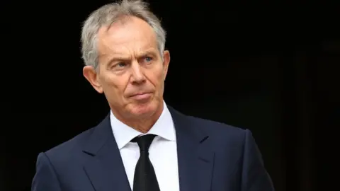 PA Tony Blair in front of a black background, in a photograph from 2012