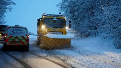 PA A snow plough clears the A69 near Stocksfield, Northumberland