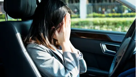 Getty Images A woman in distress