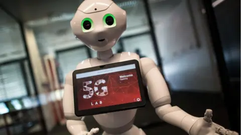 Getty Images Pepper robot with screen advertising 5G logo