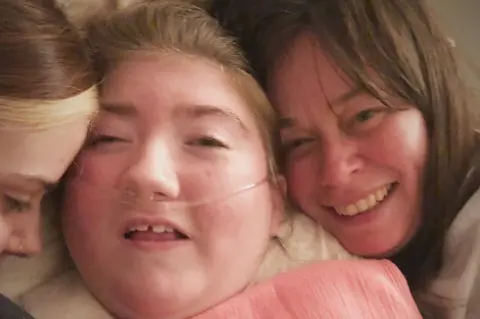 Freya Hunter with mother Carolynne (right) and sister Katie (left)