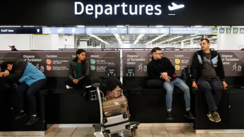 Tolga Akemn/EPA-EFE/REX/Shutterstock  Passengers at Luton Airport on Wednesday