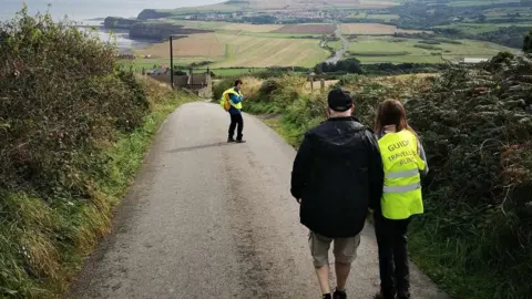 Travelling Blind Andrew Elliker-Reeve and volunteers