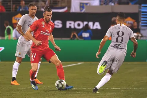 Getty Images Gareth Bale of Real Madrid moves the ball past Diego Perotti during their match at MetLife Stadium on August 7, 2018 in East Rutherford, New Jersey.