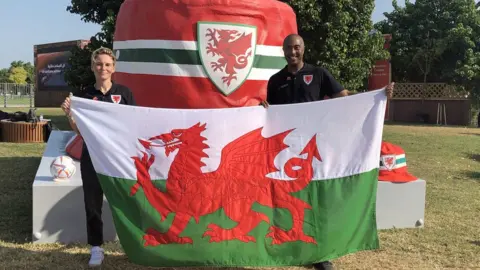 Bronwyn Weatherby | PA Media Wales football player Jess Fishlock and former Olympic hurdler Colin Jackson with the giant bucket hat in Doha