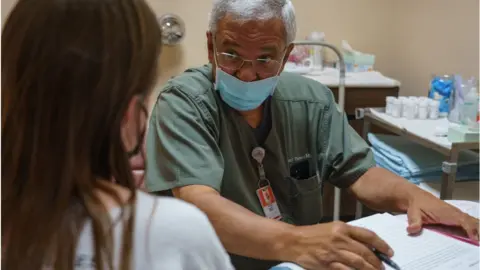 Getty Images An abortion provider in neighbouring New Mexico speaks to a woman from Oklahoma