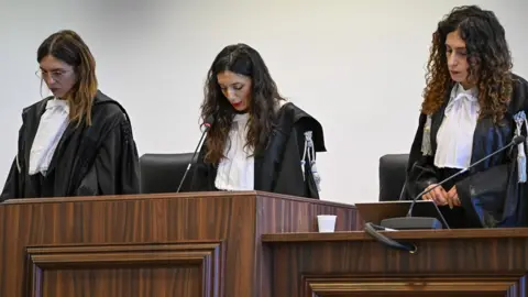 AP President of the court judge Brigida Cavasino, center, flanked by judges Claudia Caputo, left, and Germana Radice