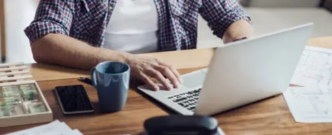 Getty Images A man at a laptop