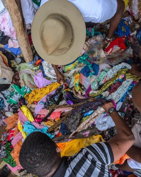 Andrew Esiebo Amah selecting scarves at Hedzranawoe Market