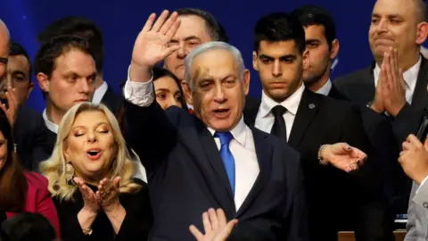 Reuters Benny Gantz waves to supporters at an election night gathering in Tel Aviv on 3 March 2020