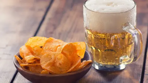 Getty Images Crisps and beer