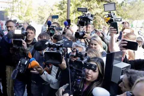 Reuters International media gathered outside Klein's hotel in Malmo, Sweden